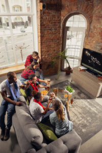 Excited Group Of People Watching Sport Match At Home